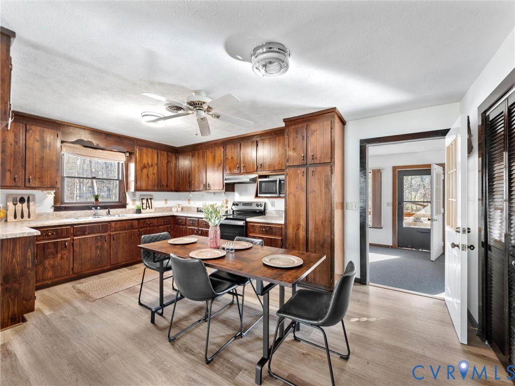 4905 Old Buckingham Road Powhatan, VA 23139 - Photo 13 of 50 a kitchen with stainless steel appliances kitchen island granite countertop a sink cabinets and refrigerator