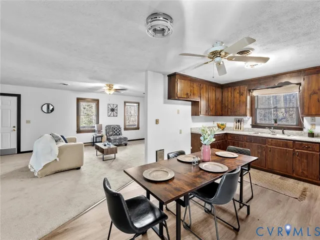 a view of a dining room with furniture and a kitchen