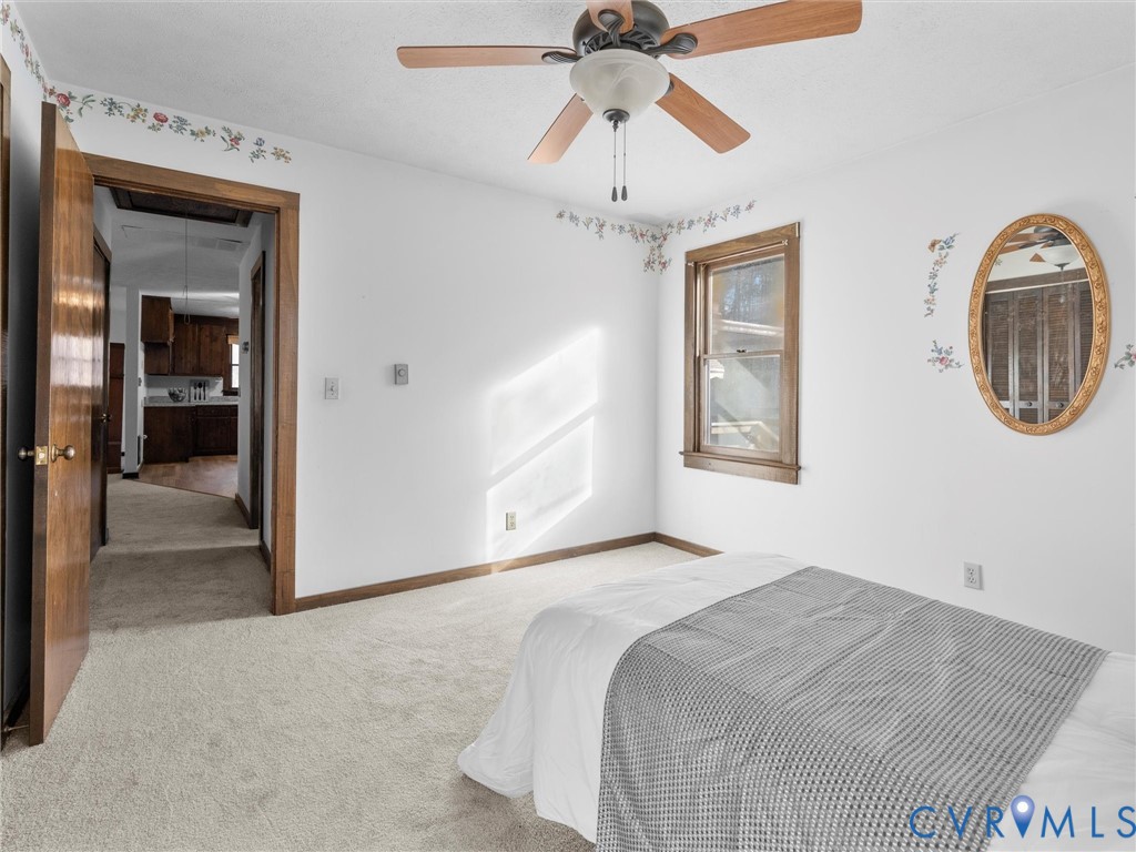 4905 Old Buckingham Road Powhatan, VA 23139 - Photo 22 of 50 a bedroom with a bed and a chandelier