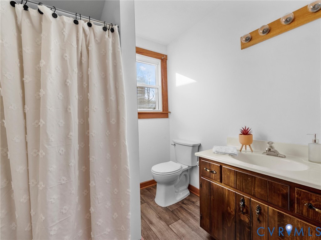 4905 Old Buckingham Road Powhatan, VA 23139 - Photo 28 of 50 a bathroom with a sink a toilet and shower curtain