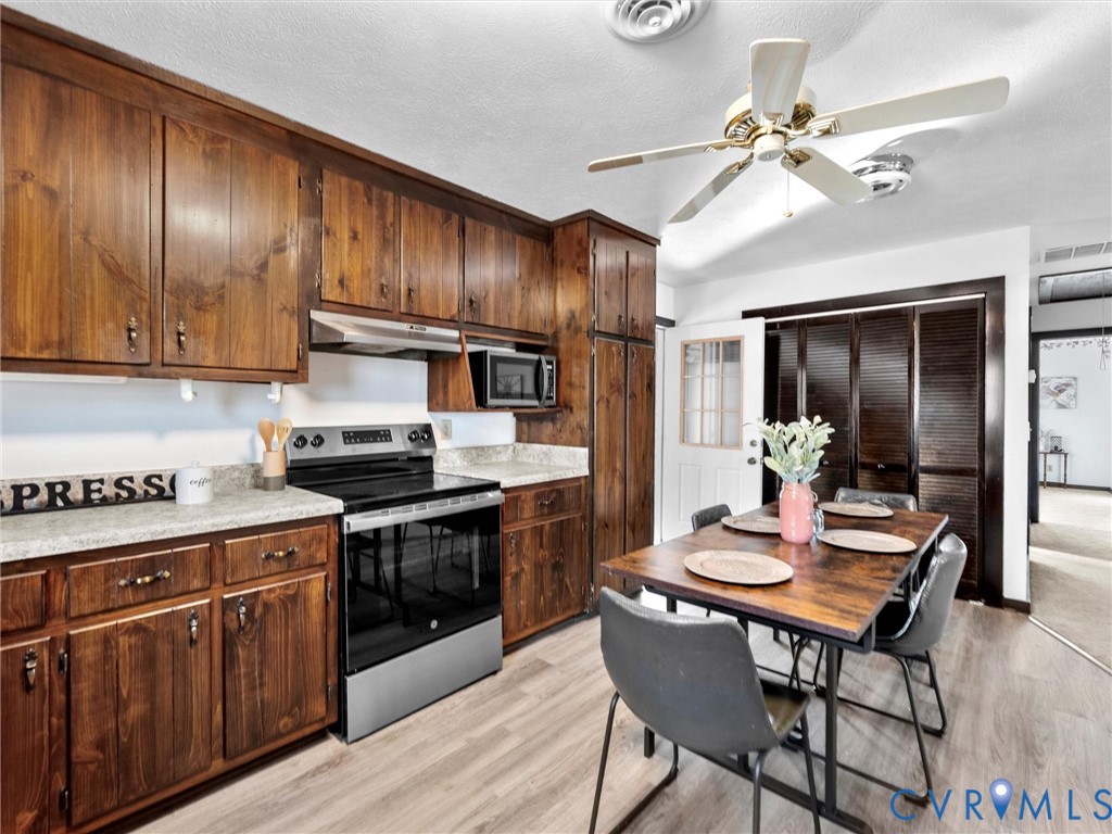 4905 Old Buckingham Road Powhatan, VA 23139 - Photo 44 of 50 a kitchen with granite countertop cabinets stainless steel appliances dining table and chairs