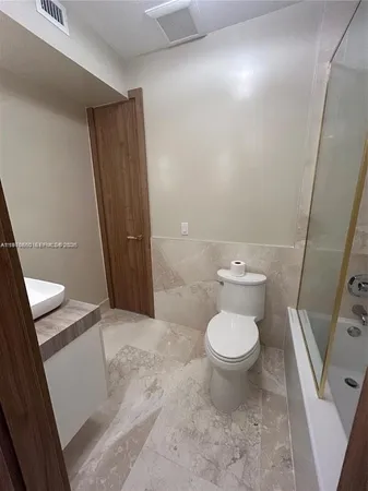 a bathroom with a toilet and a sink