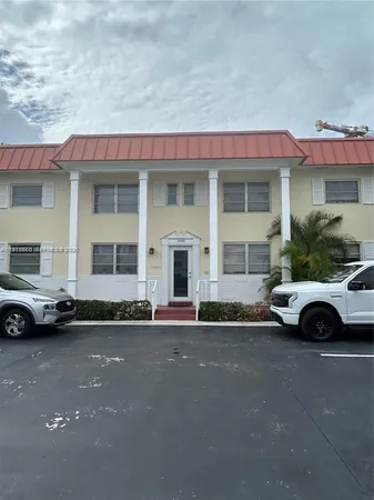 a front view of a house with a parking space