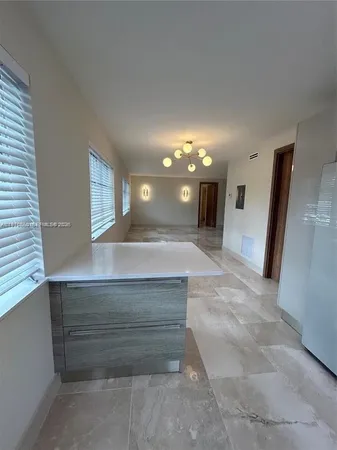 a view of spacious bathroom with a sink and a mirror