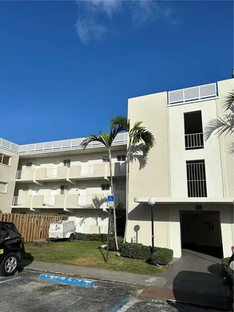 a front view of a building with garden