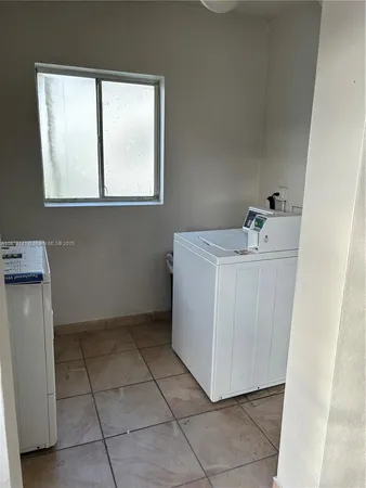 a utility room with a window dryer and washer