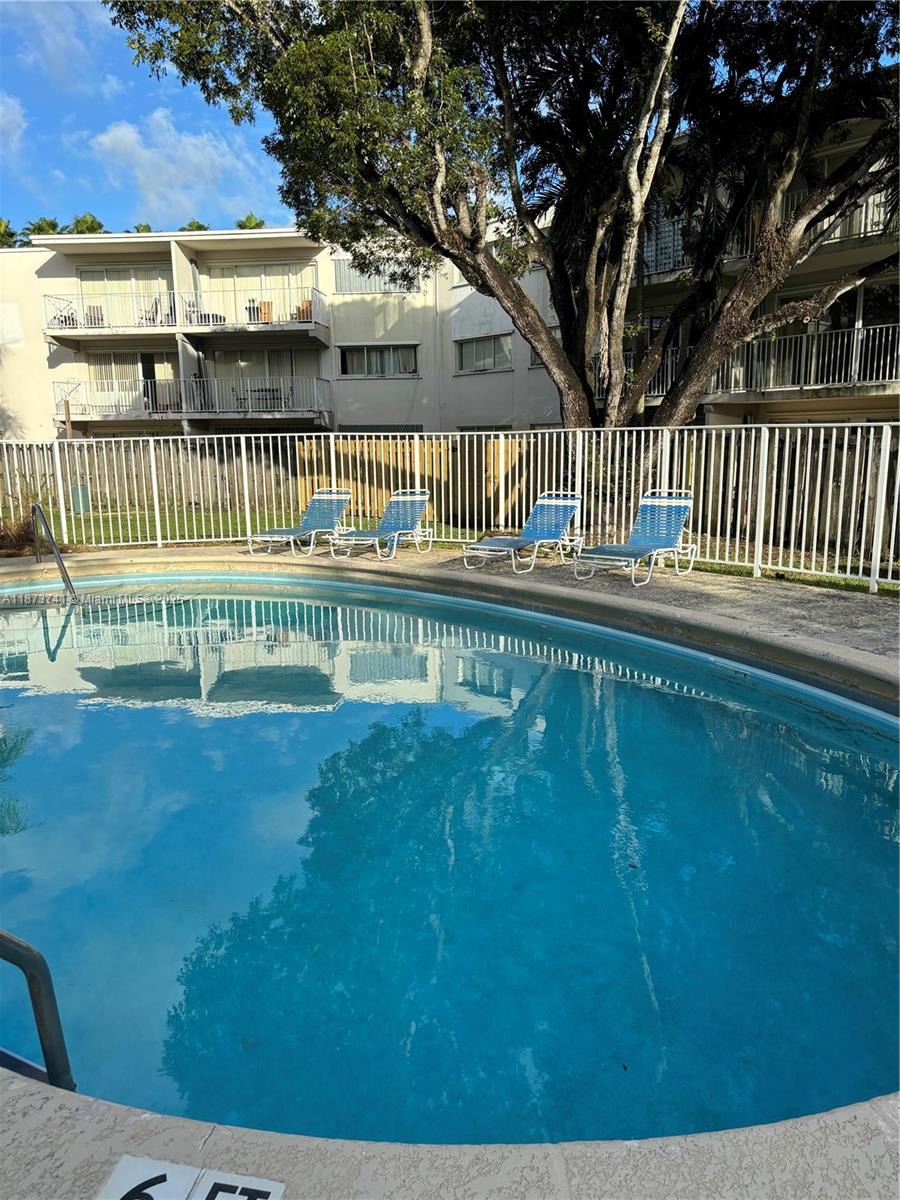 7701 Southwest 88th Street, Unit B224 Miami, FL 33156 - Photo 14 of 14 a view of a house with a yard