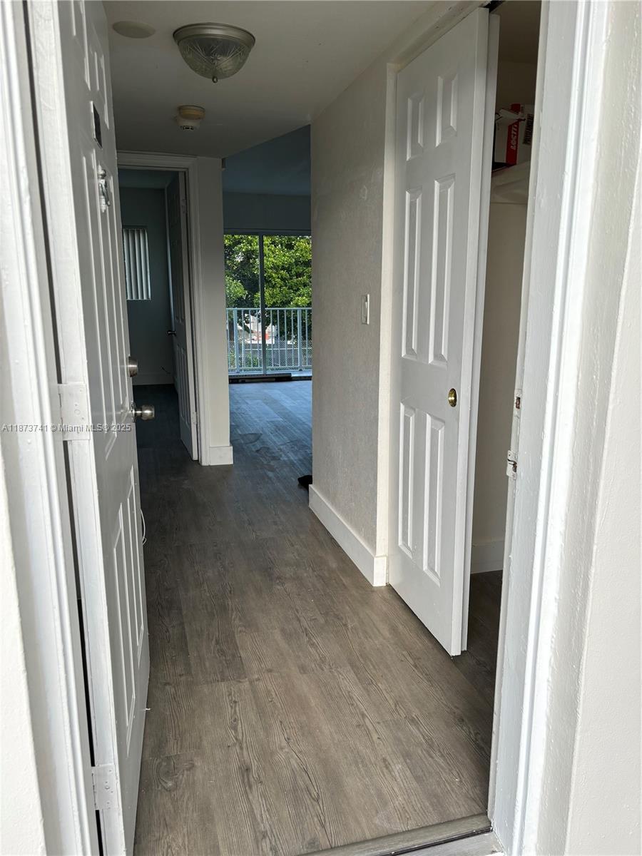 7701 Southwest 88th Street, Unit B224 Miami, FL 33156 - Photo 7 of 14 a view of a hallway to rooms