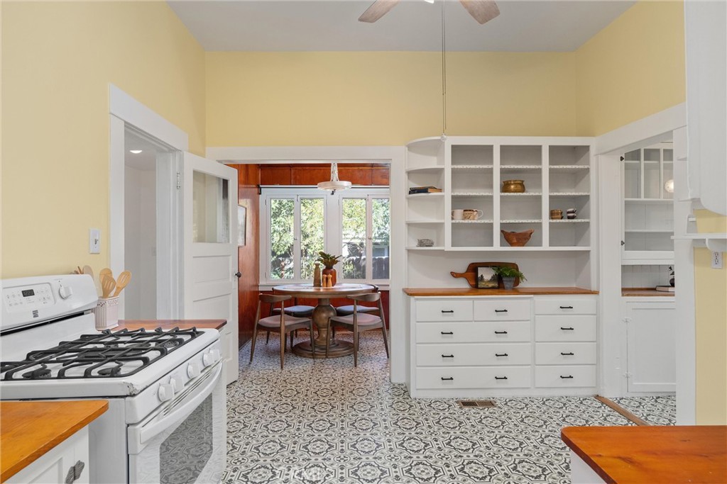 1805 Hemlock Street Chico, CA 95928 - Photo 22 of 62 a kitchen with a stove and a wooden cabinets