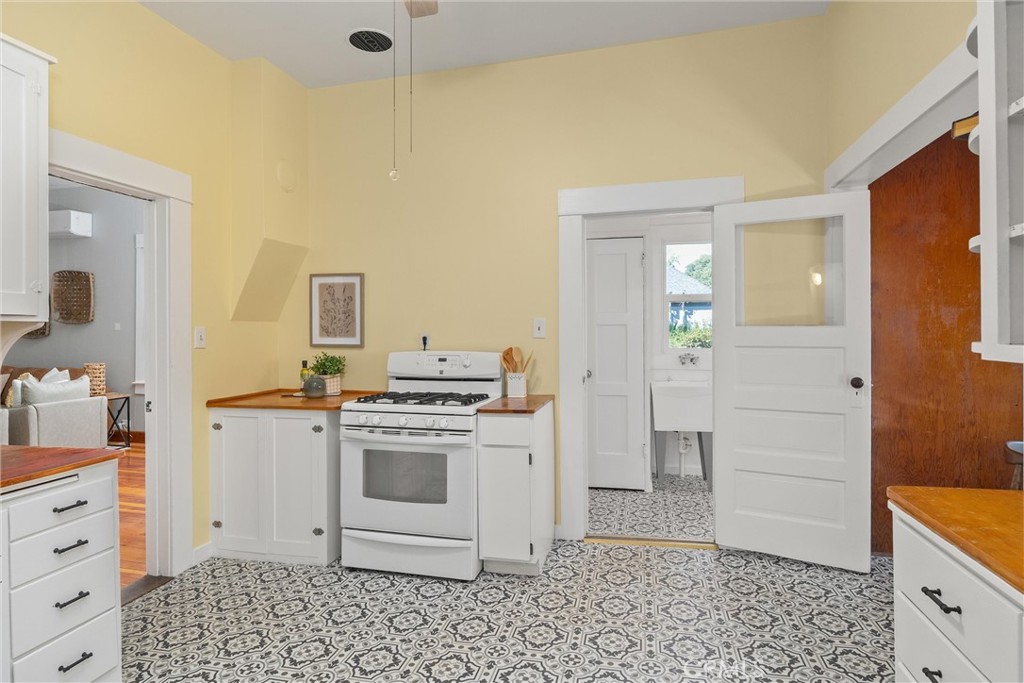 1805 Hemlock Street Chico, CA 95928 - Photo 25 of 62 a kitchen with a stove a sink and a refrigerator