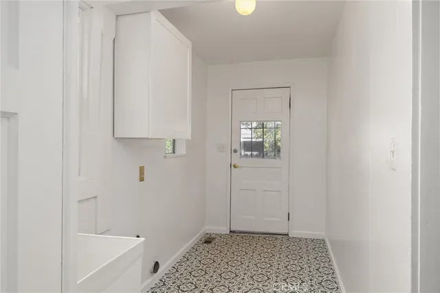 a front view of a house with plants