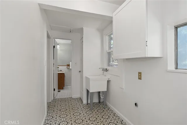 a living room with furniture and a book shelf