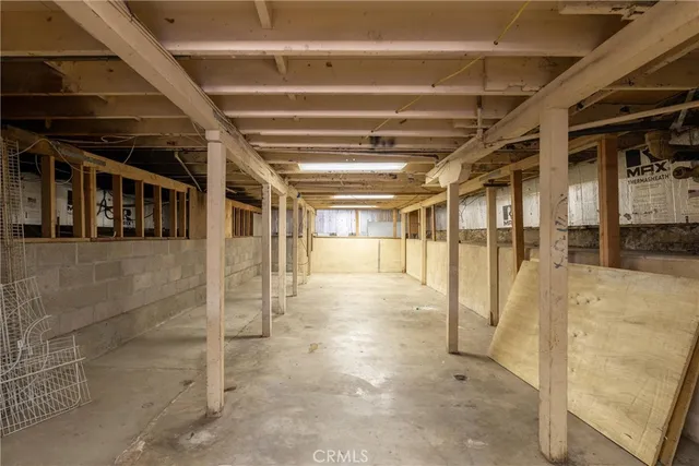 a kitchen with a table chairs sink and cabinets