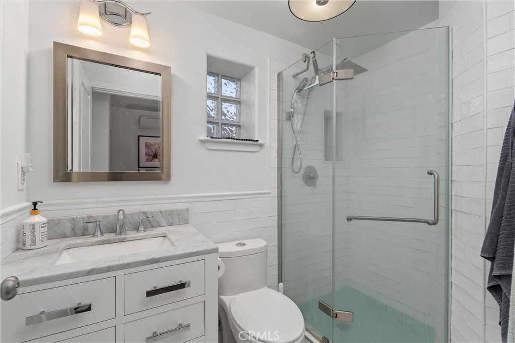 1805 Hemlock Street Chico, CA 95928 - Photo 59 of 62 a bathroom with a granite countertop shower sink vanity mirror and toilet