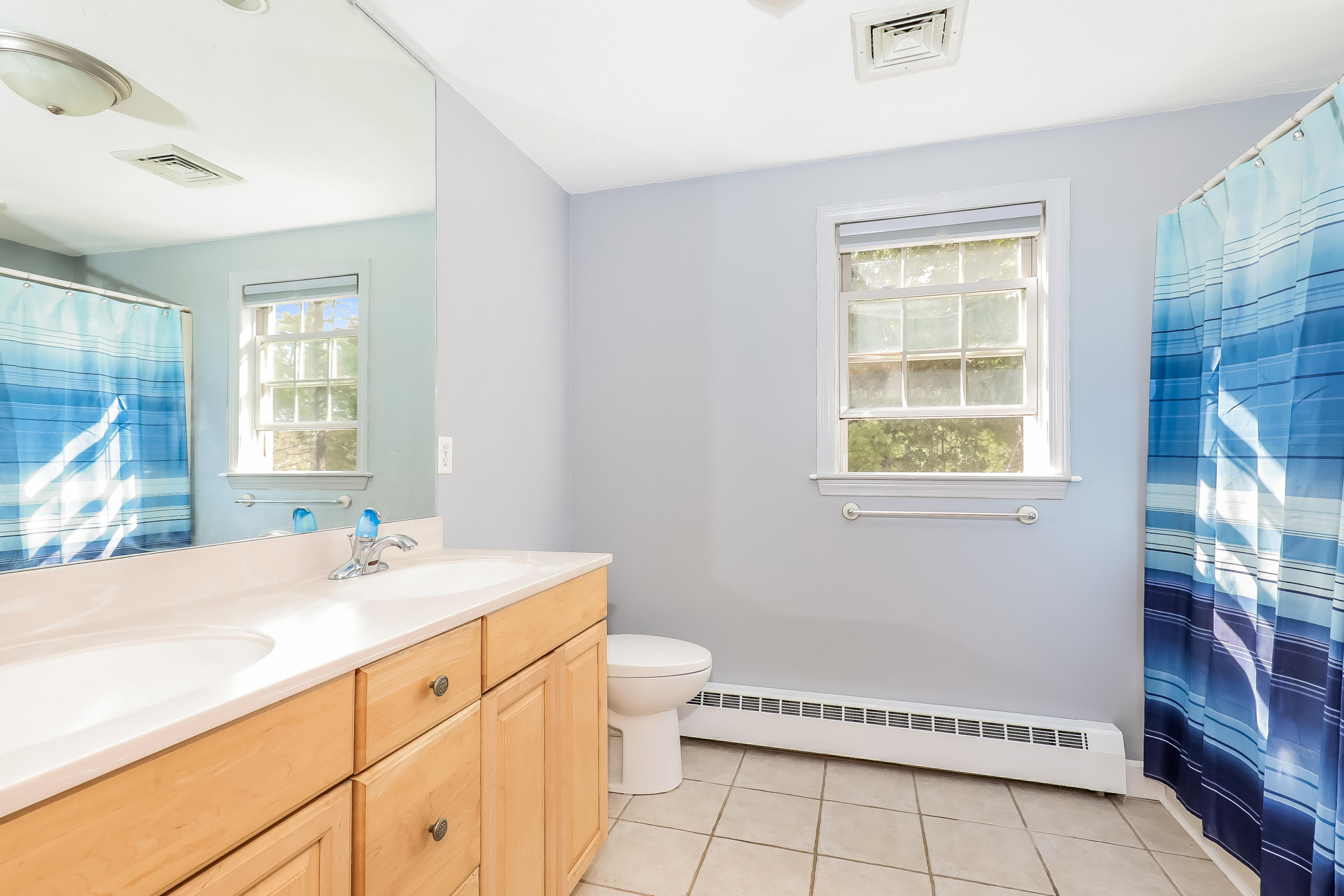 39 Station Street Wareham, MA 02571 - Photo 11 of 22 a bathroom with a sink a toilet and a window