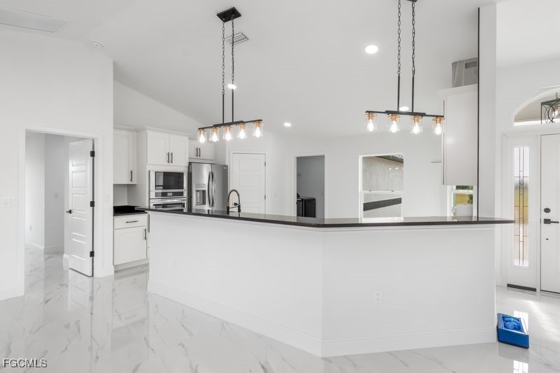 14461 Southeast 80th Street Morriston, FL 32668 - Photo 11 of 37 a view of a kitchen with a refrigerator a microwave and a sink