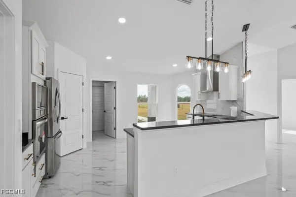 a kitchen with stainless steel appliances a sink and a refrigerator