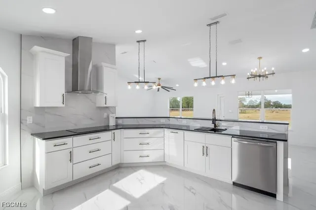 a kitchen with granite countertop white cabinets and white appliances