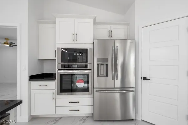 a kitchen with cabinets and stainless steel appliances
