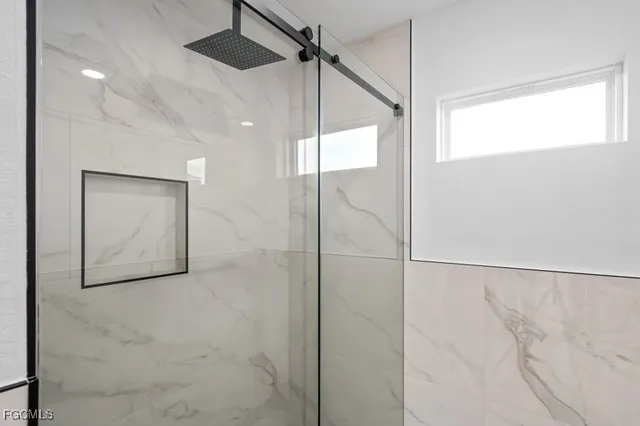 a bathroom with a shower and a mirror