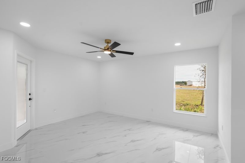 14461 Southeast 80th Street Morriston, FL 32668 - Photo 22 of 37 an empty room with a window and a ceiling fan