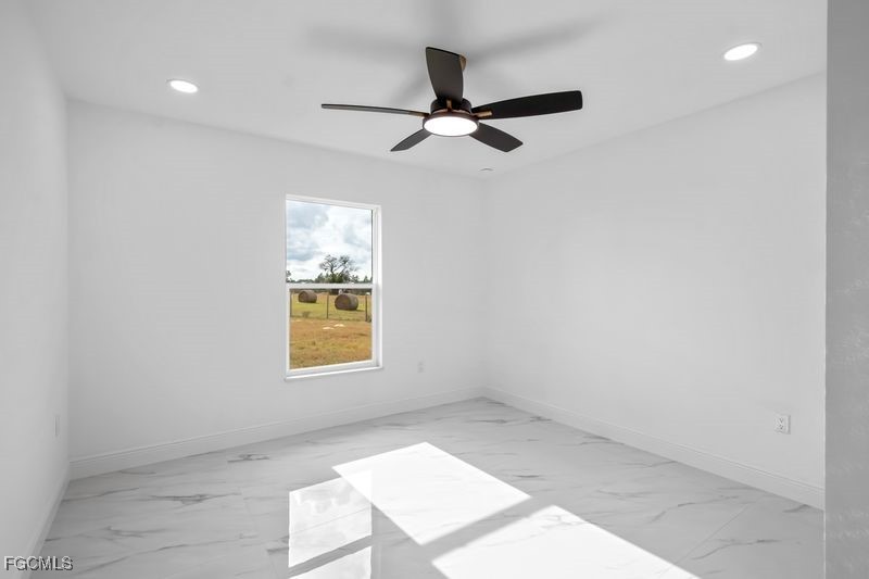 14461 Southeast 80th Street Morriston, FL 32668 - Photo 27 of 37 an empty room with windows and fan