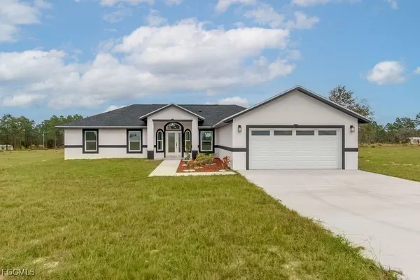 a front view of house with yard and green space