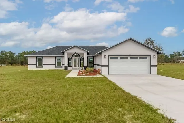 a front view of house with yard and green space