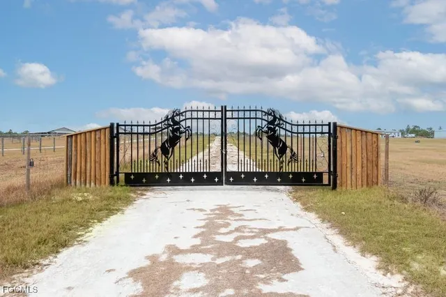 a view of swimming pool with furniture in front of house