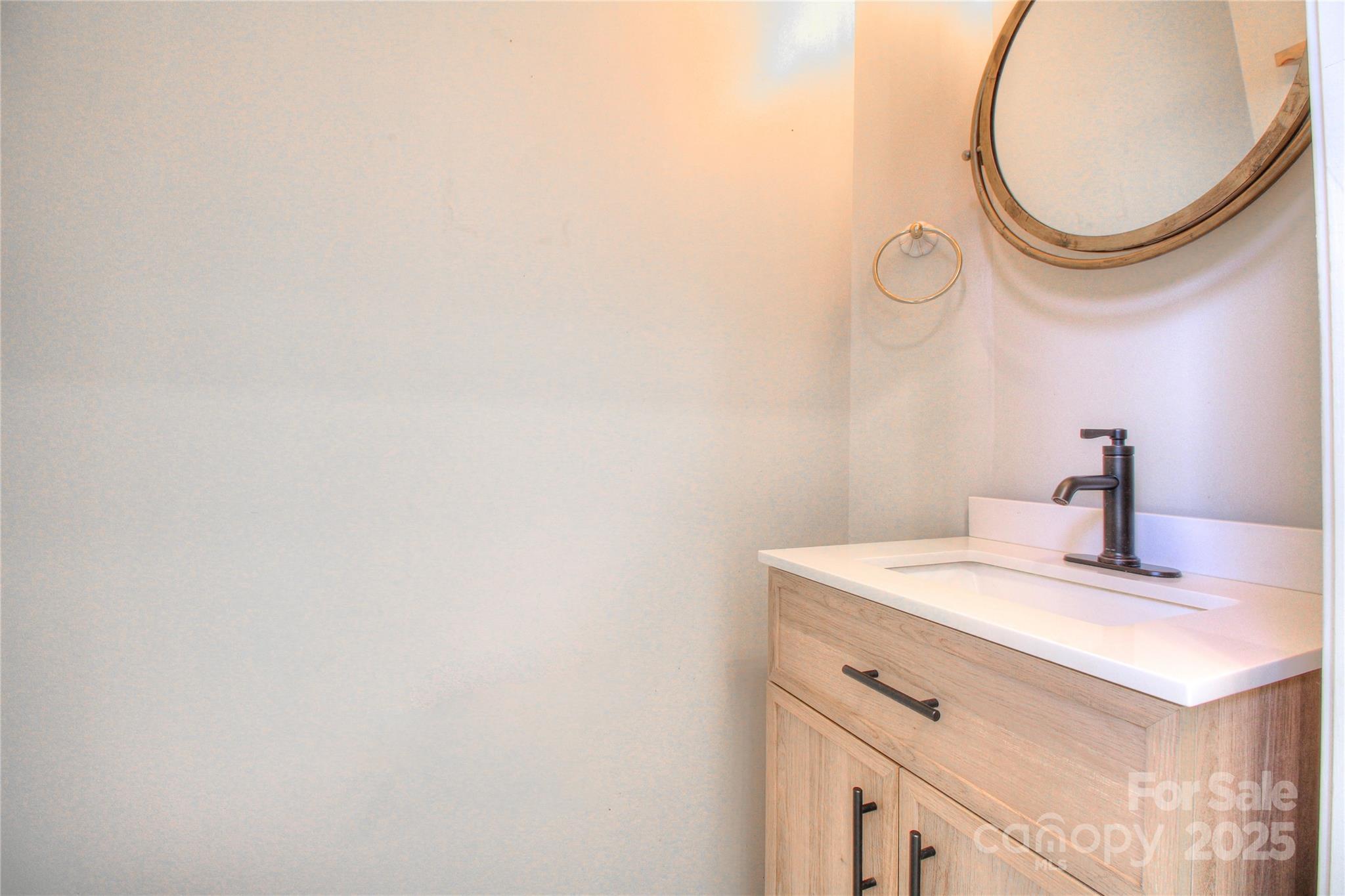 8414 Bampton Drive Concord, NC 28027 - Photo 12 of 32 a bathroom with a sink and a mirror