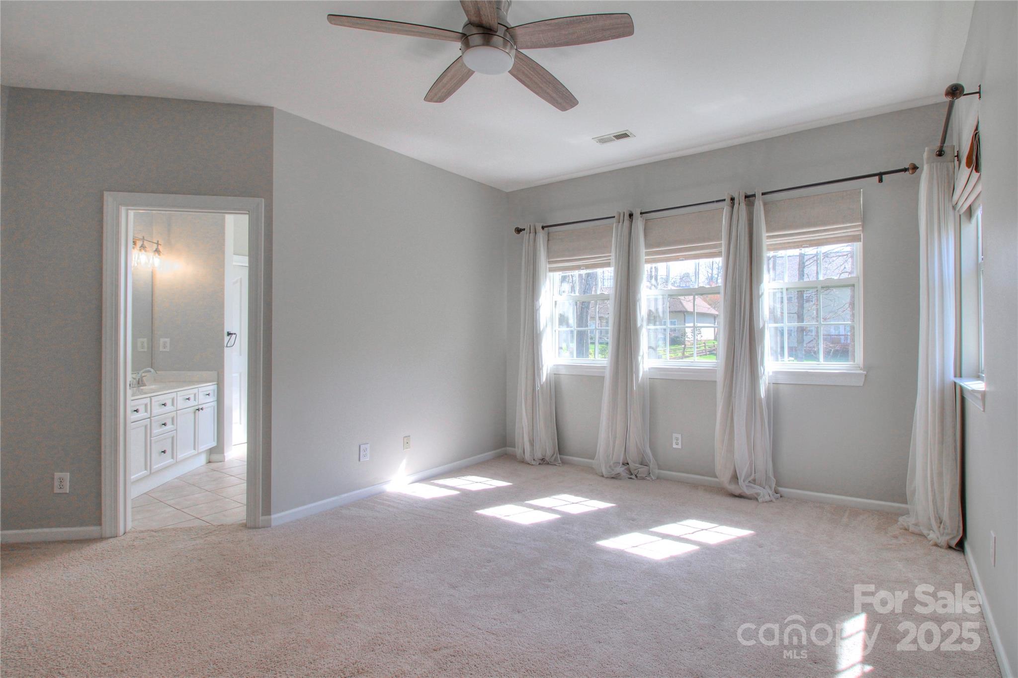 8414 Bampton Drive Concord, NC 28027 - Photo 16 of 32 a view of a big room with windows and chandelier fan