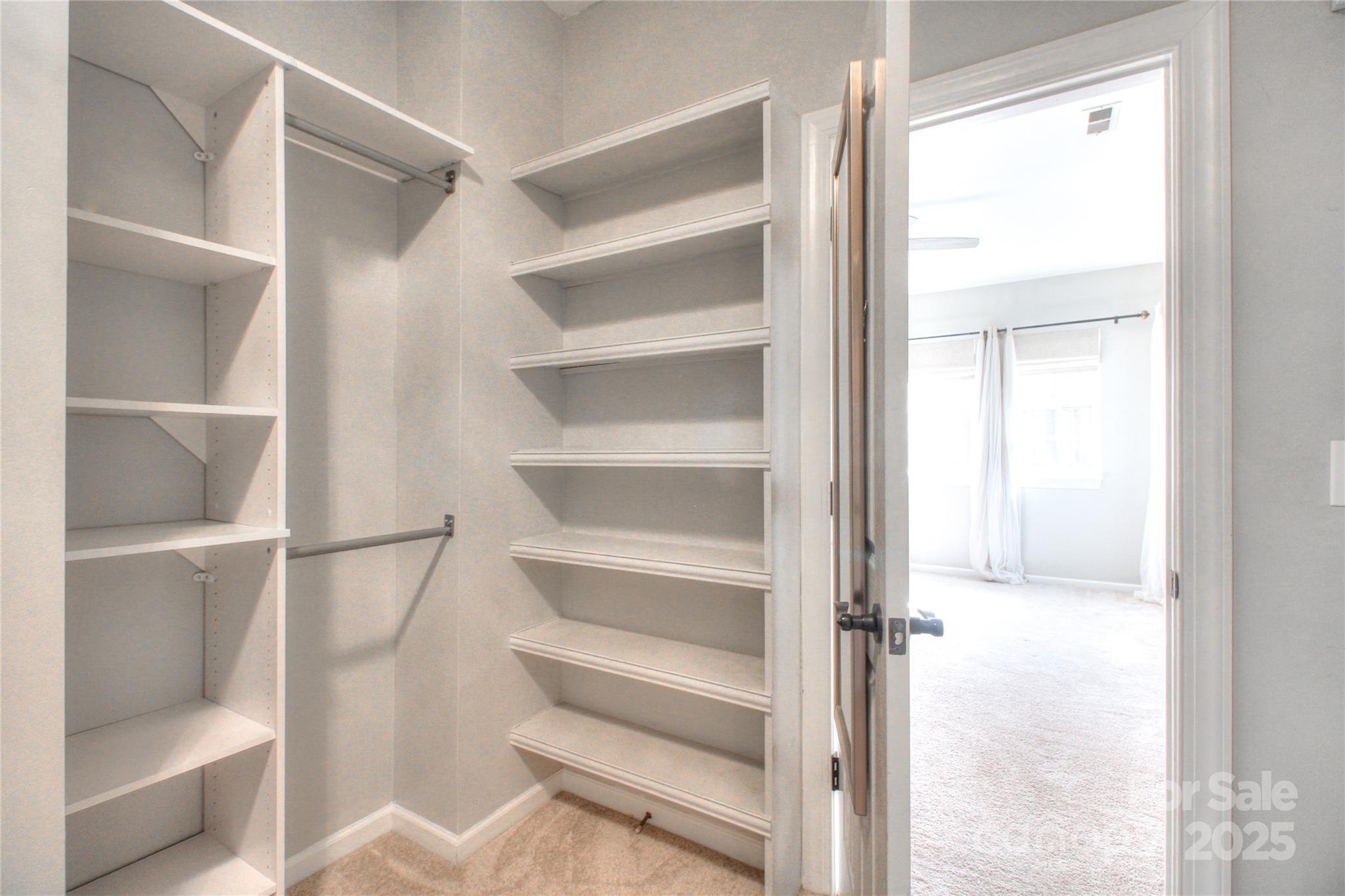 8414 Bampton Drive Concord, NC 28027 - Photo 19 of 32 a view of walk in closet with empty racks