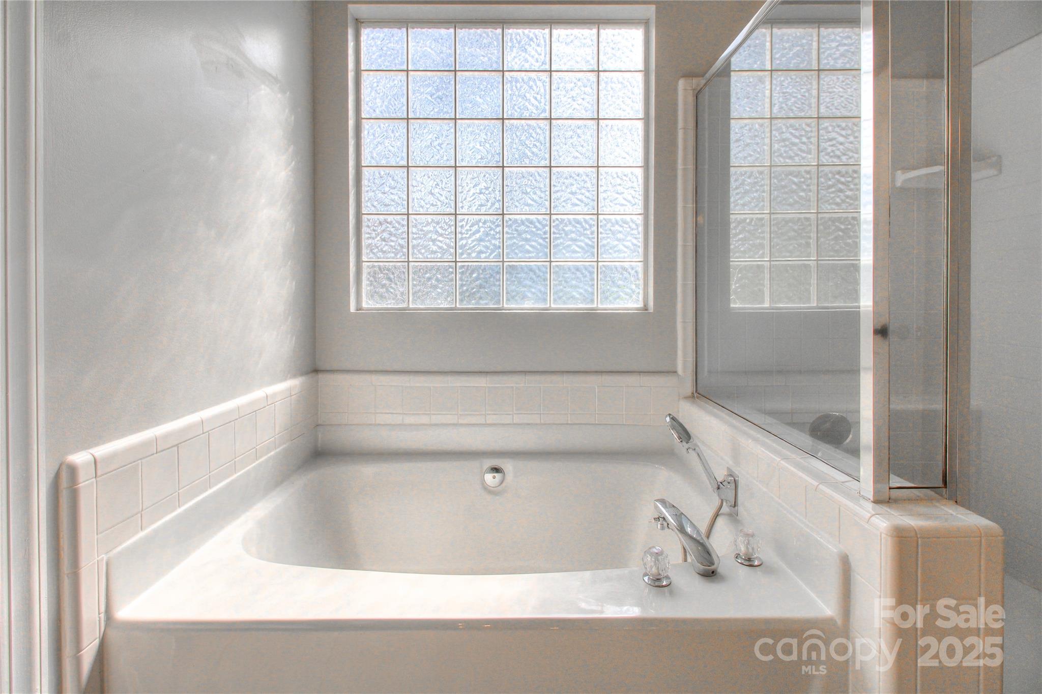 8414 Bampton Drive Concord, NC 28027 - Photo 21 of 32 a bath tub sitting next to a window