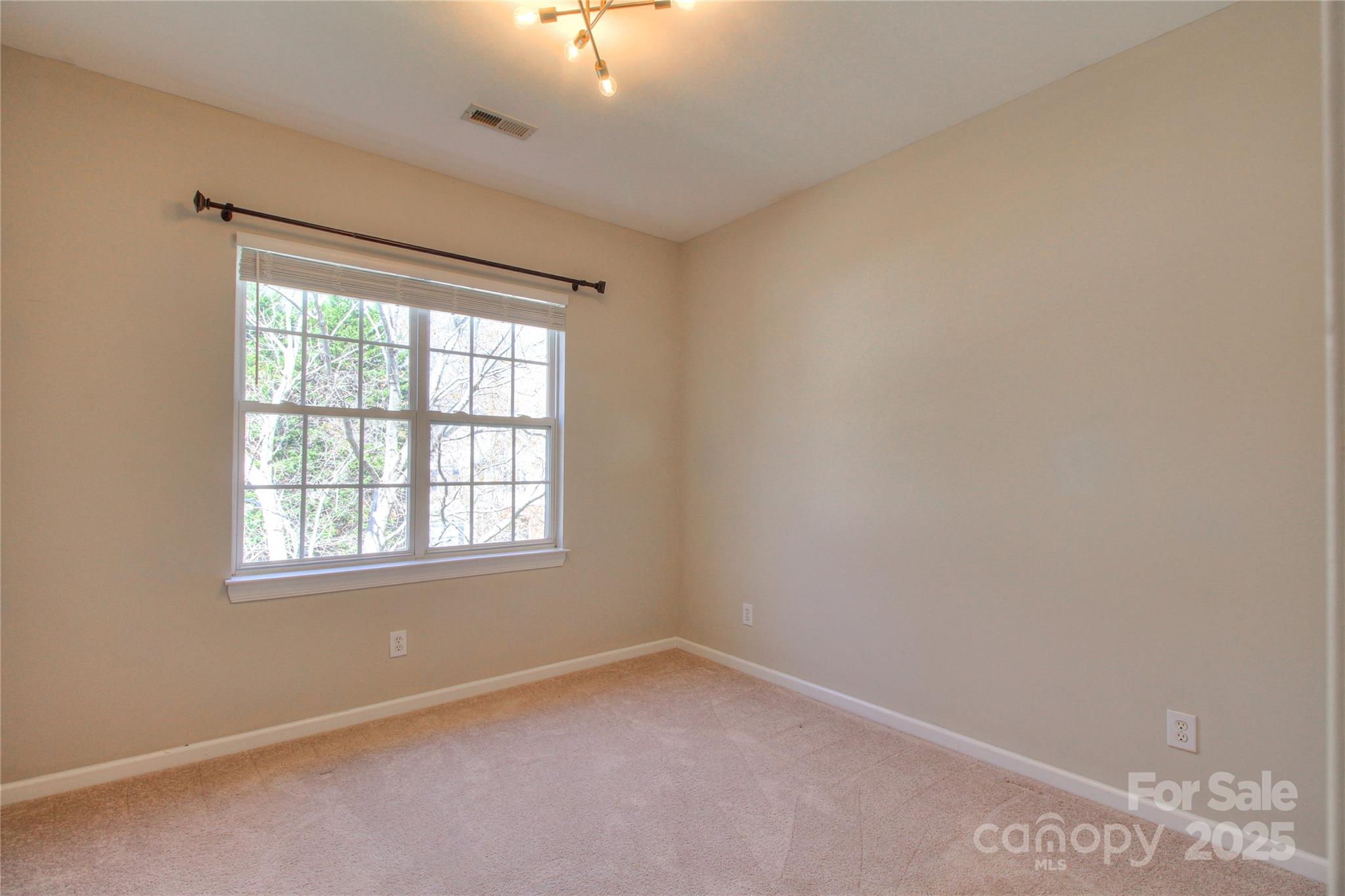 8414 Bampton Drive Concord, NC 28027 - Photo 25 of 32 an empty room with a window