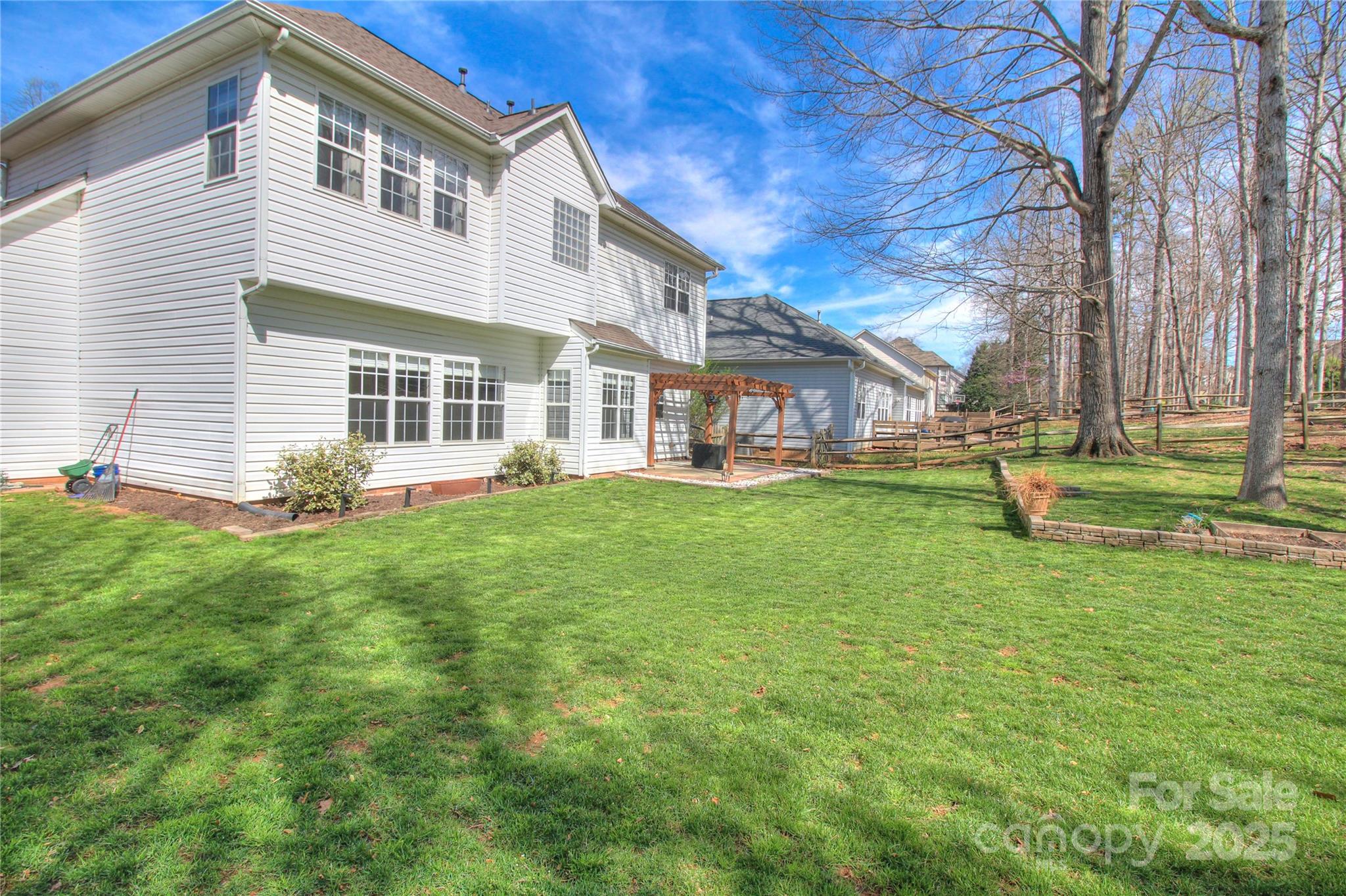 8414 Bampton Drive Concord, NC 28027 - Photo 29 of 32 a front view of a house with a yard table and chairs