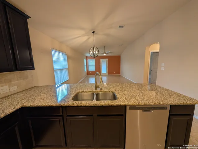 a kitchen with granite countertop a sink and a granite counter top