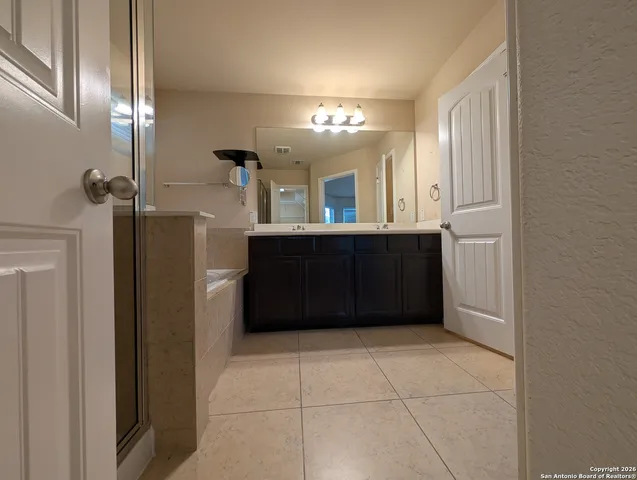 a bathroom with a vanity and a mirror