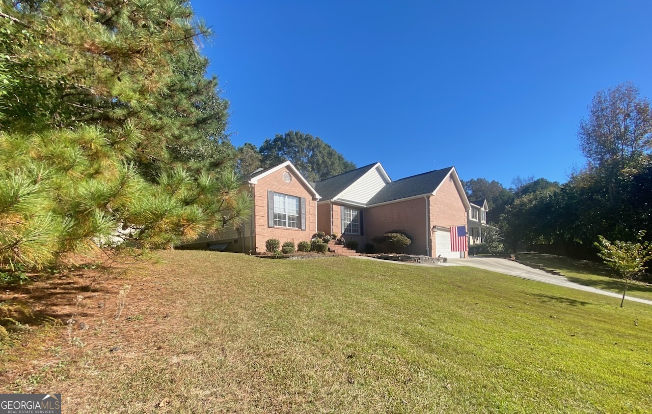 103 Fawn Court Byron, GA 31008 - Photo 22 of 23 a front view of a house with a yard and garage