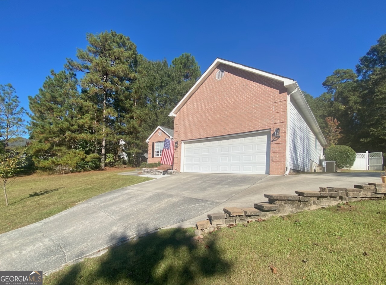 103 Fawn Court Byron, GA 31008 - Photo 23 of 23 a view of a house with a yard and garage