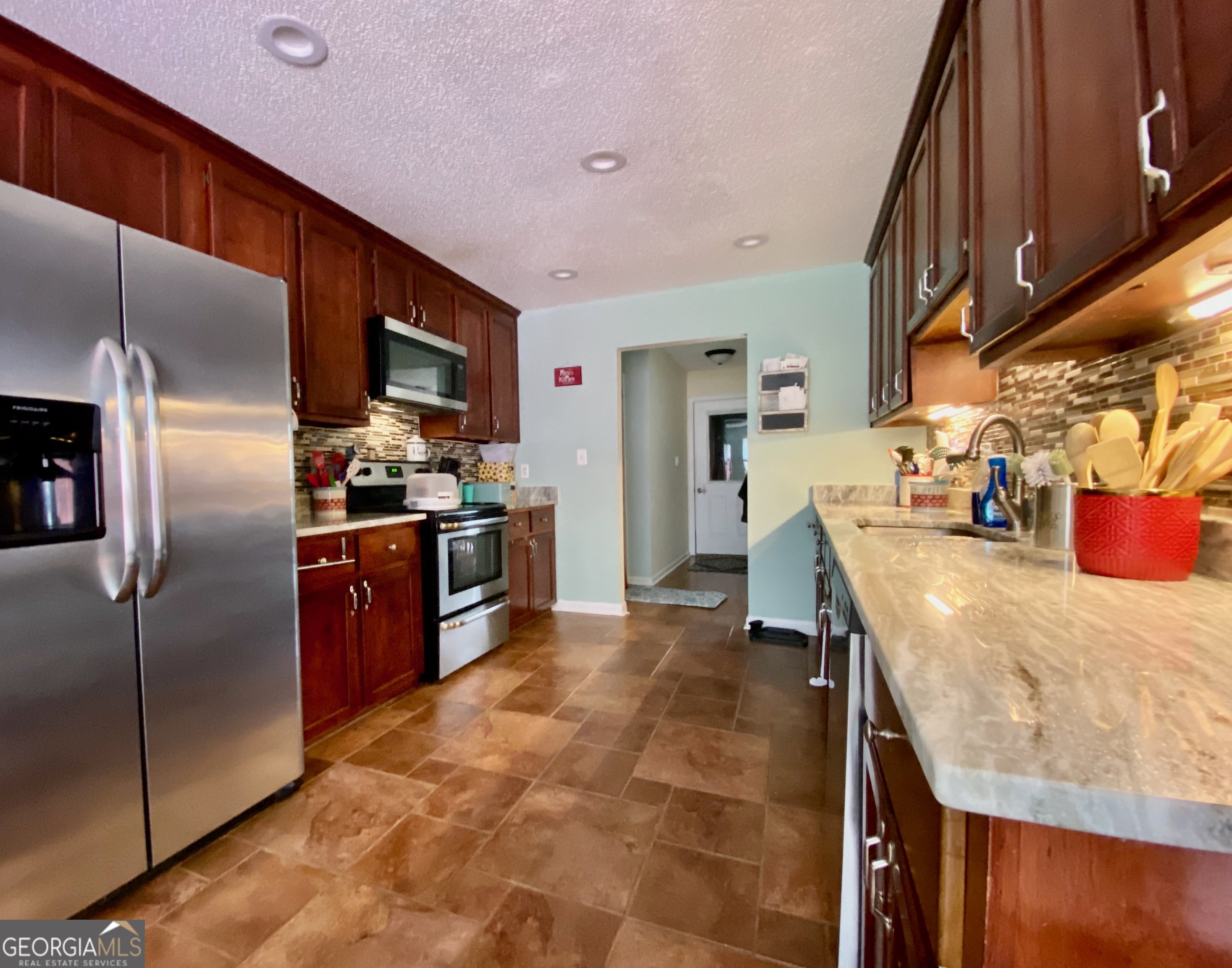 103 Fawn Court Byron, GA 31008 - Photo 8 of 23 a kitchen with stainless steel appliances granite countertop a sink a stove and a refrigerator
