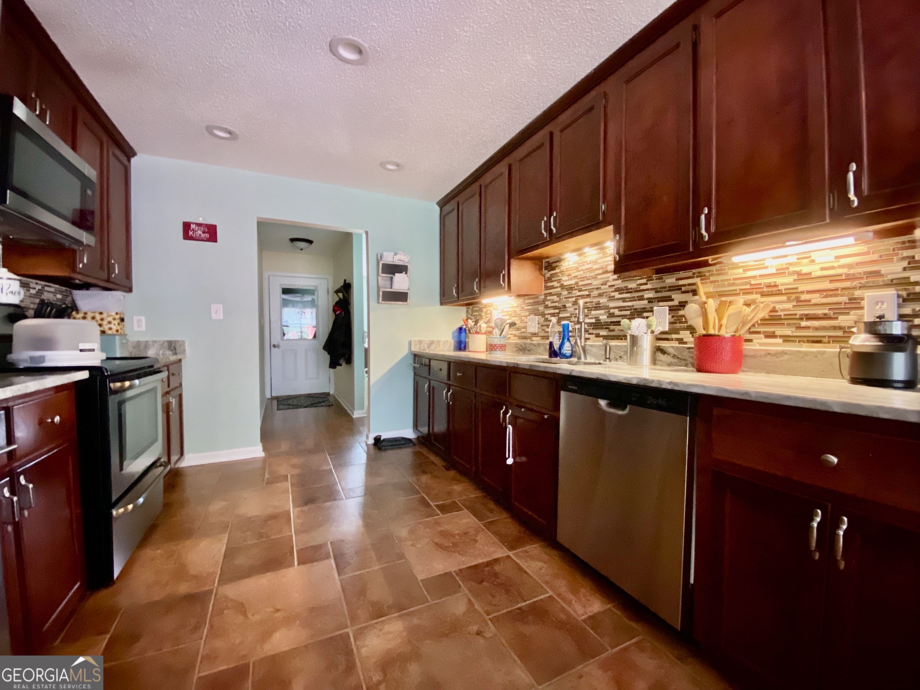 103 Fawn Court Byron, GA 31008 - Photo 9 of 23 a kitchen with stainless steel appliances granite countertop a sink stove and cabinets