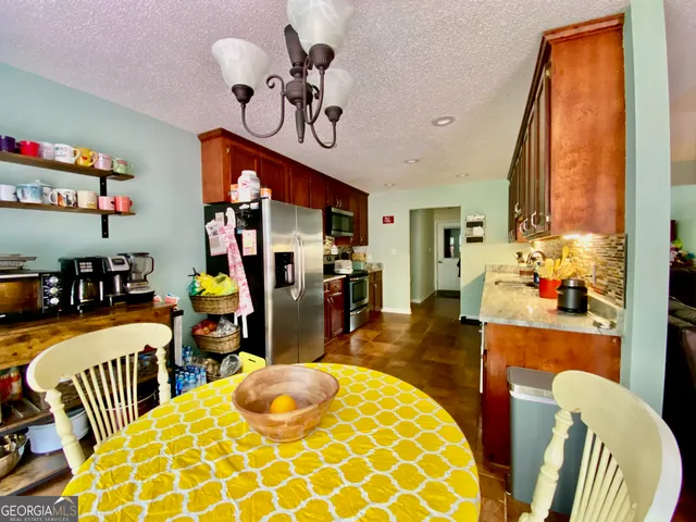 a spacious bedroom with a bed and a chandelier