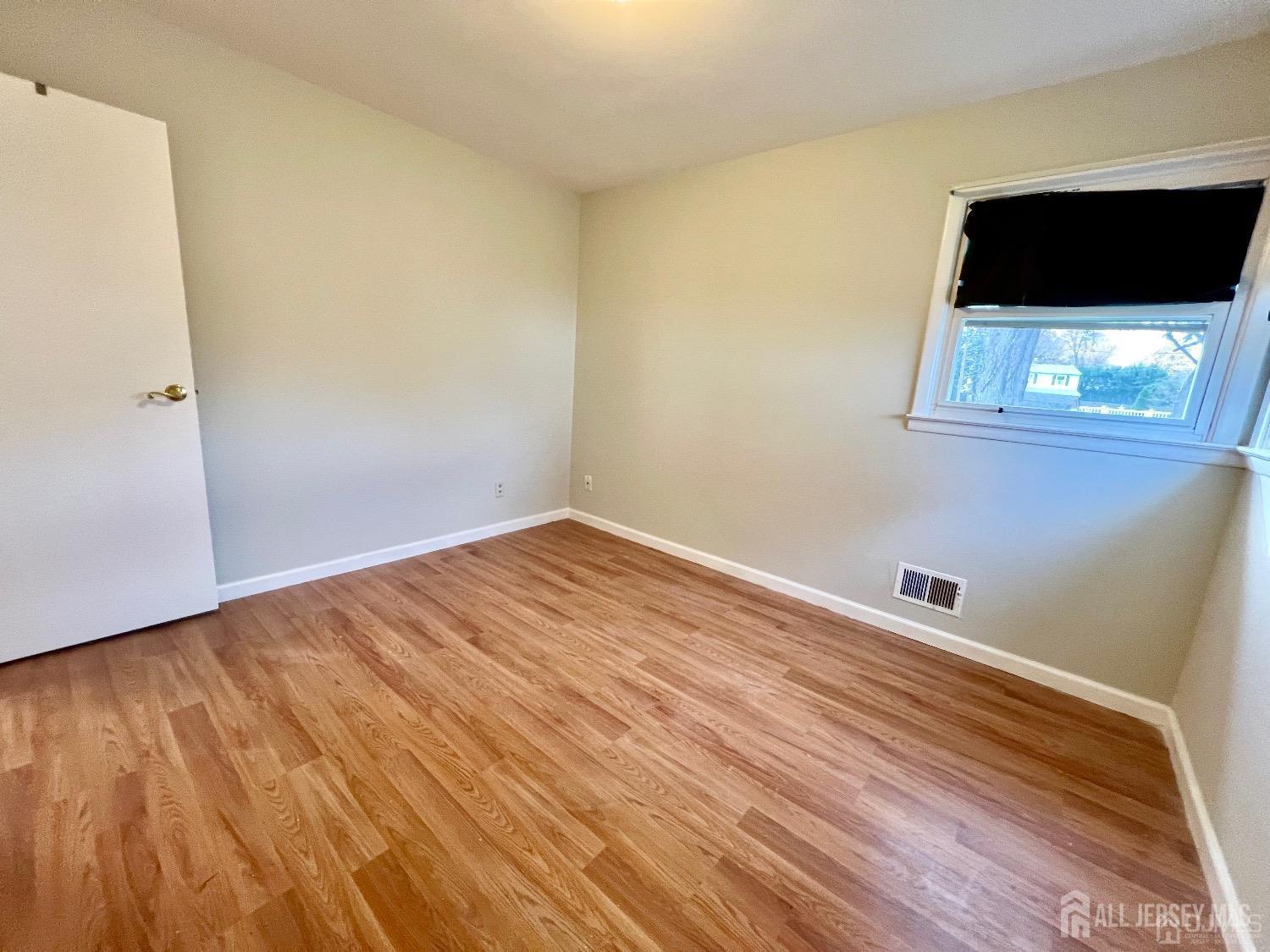 340 Old Post Road Edison, NJ 08817 - Photo 14 of 23 a view of a room with wooden floor and black wall painting