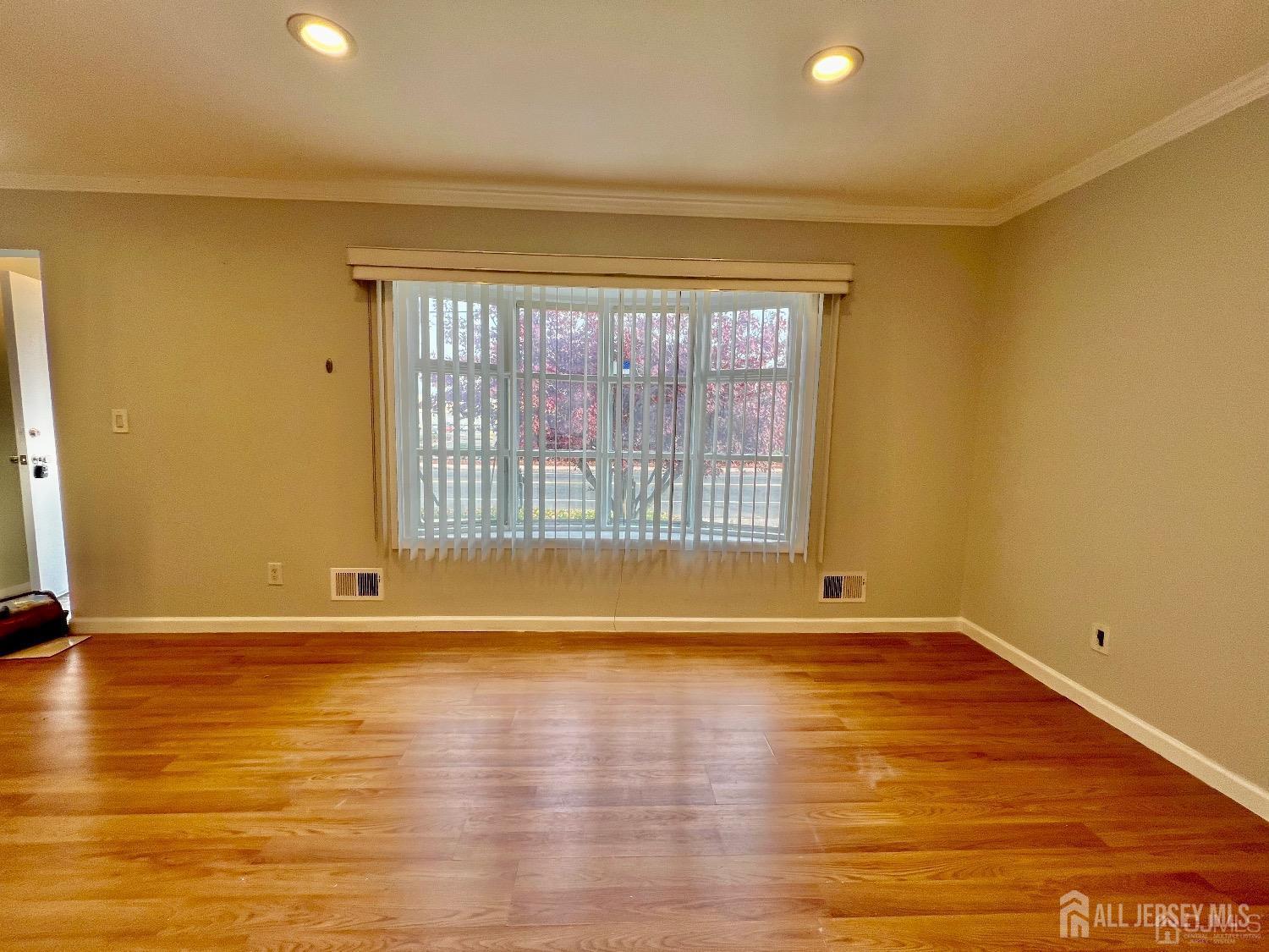 340 Old Post Road Edison, NJ 08817 - Photo 4 of 23 a view of an empty room with wooden floor and a window