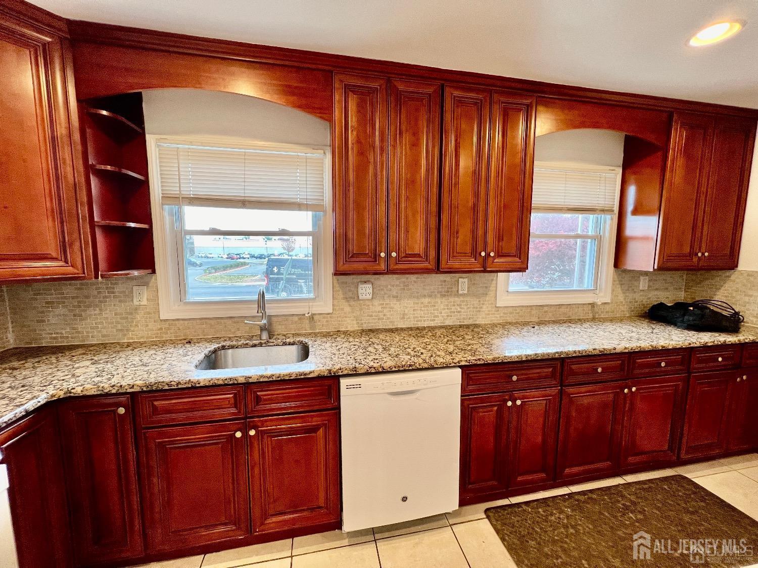 340 Old Post Road Edison, NJ 08817 - Photo 6 of 23 a kitchen with granite countertop wooden cabinets stainless steel appliances a sink and a window