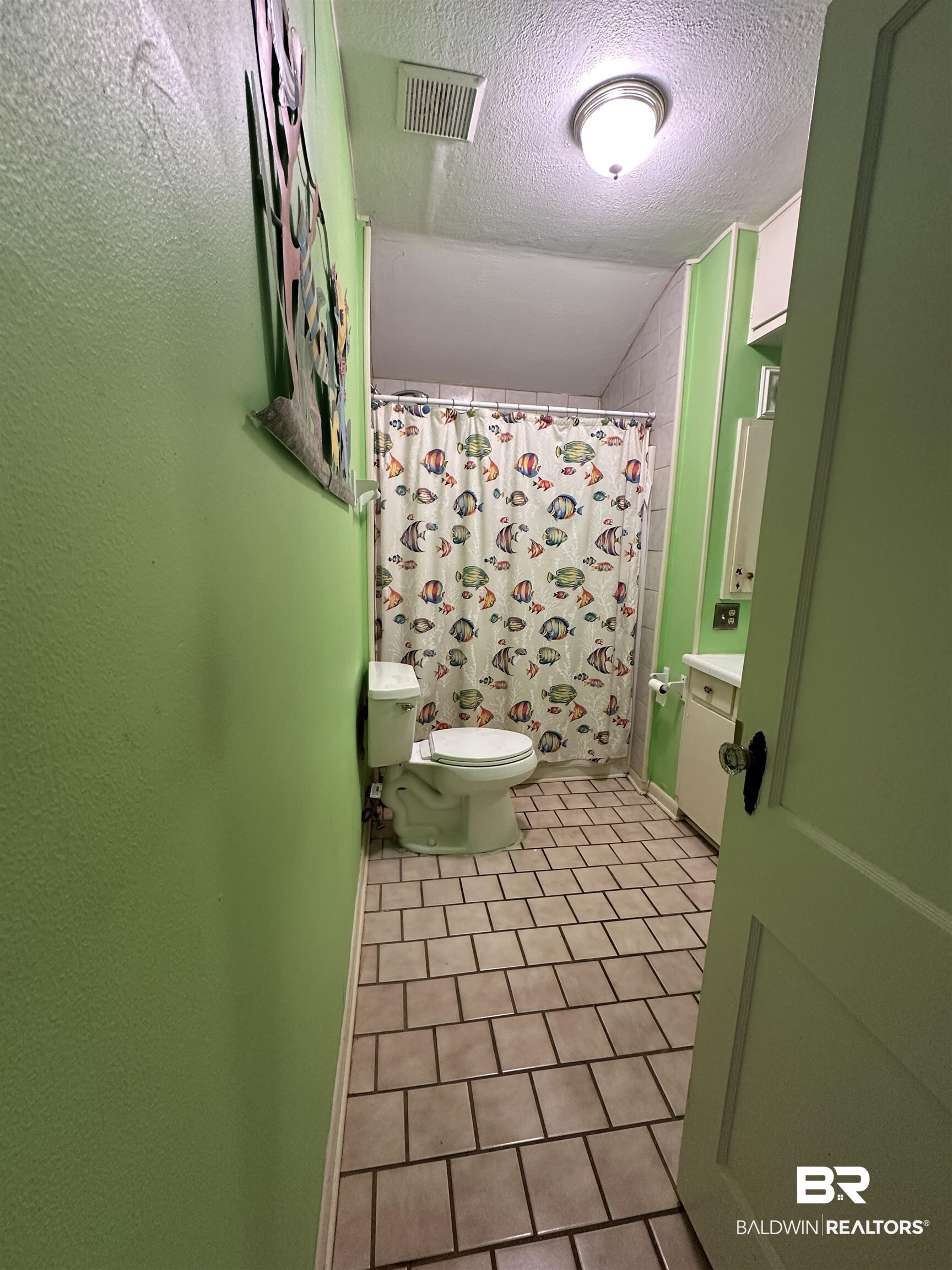 16646 County Road 26 Foley, AL 36535 - Photo 12 of 21 Bathroom with tile patterned floors, lofted ceiling, toilet, a textured ceiling, and a shower with shower curtain