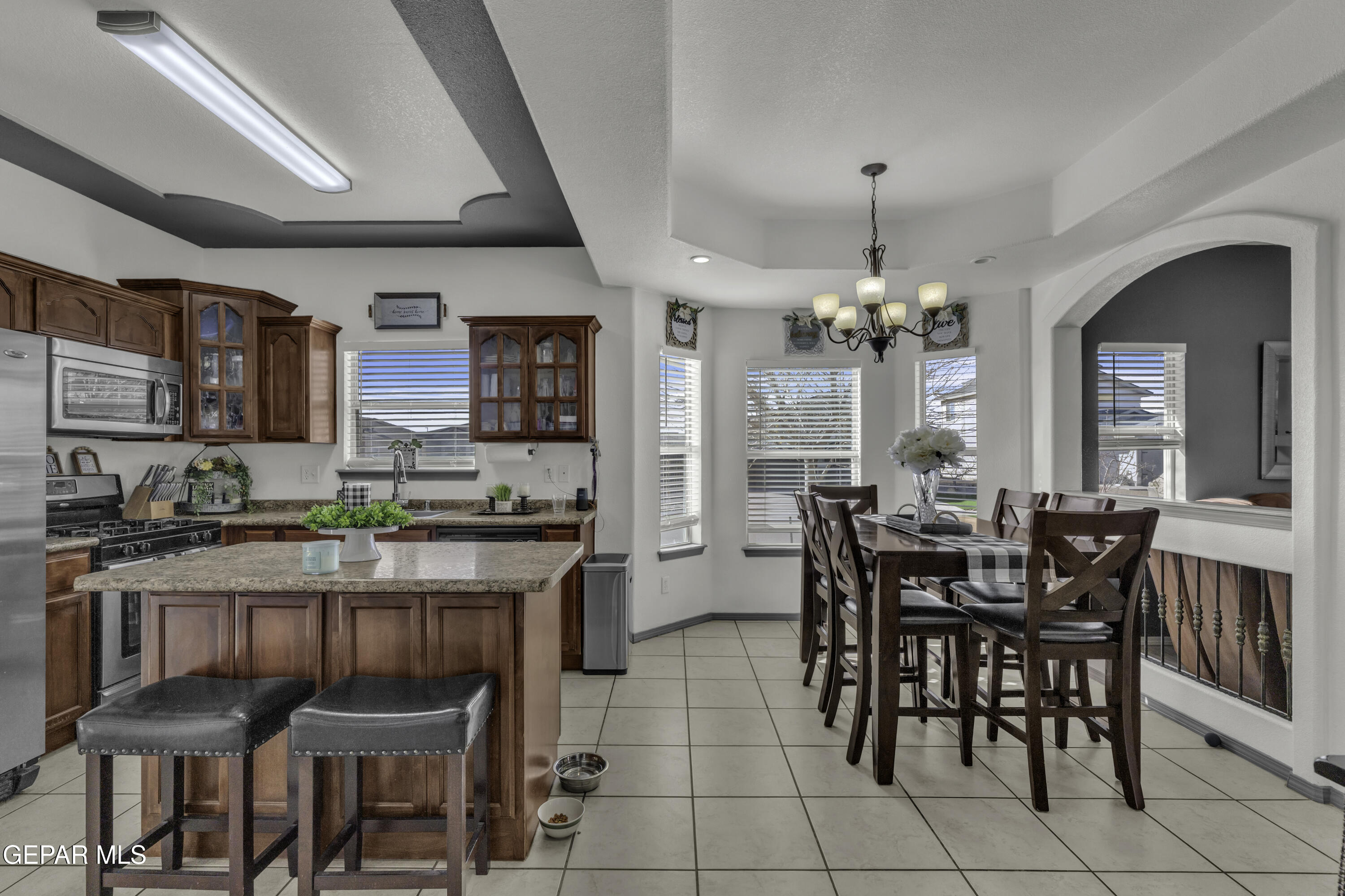 14401 Delta Point Court El Paso, TX 79938 - Photo 11 of 49 a kitchen with stainless steel appliances granite countertop table chairs and a stove
