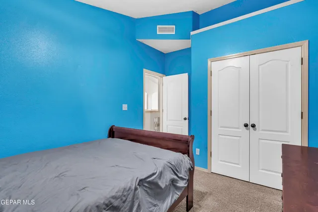 a bedroom with a bed and a lamp