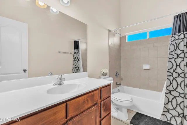 a bathroom with a sink a toilet a mirror and shower