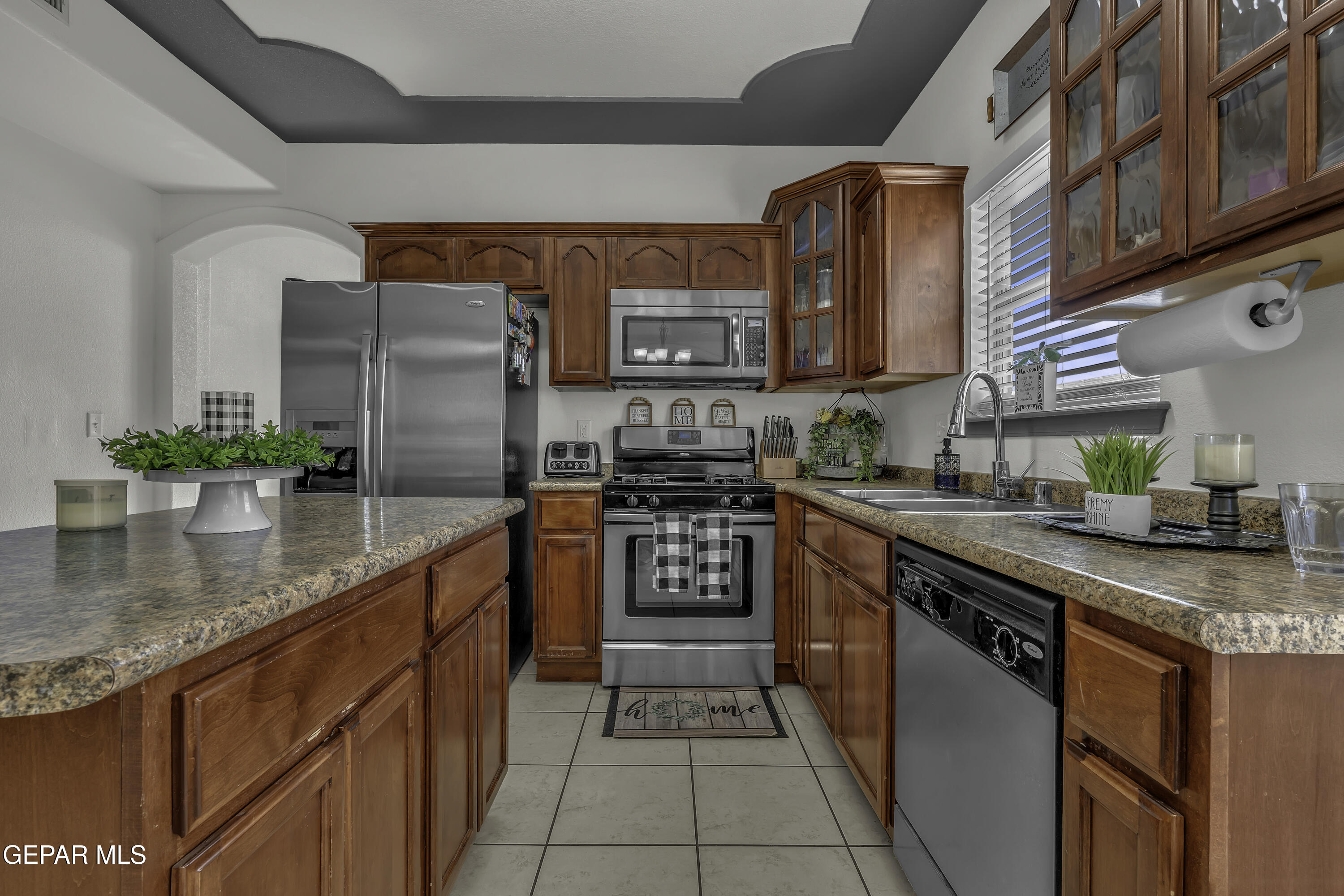 14401 Delta Point Court El Paso, TX 79938 - Photo 15 of 49 a kitchen with stainless steel appliances granite countertop a stove a sink and a refrigerator